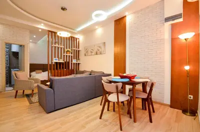 a living room with a couch and a table and chairs at Djardin in Kotor
