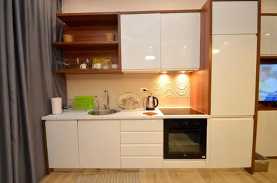 a small kitchen with white cabinets and a sink at Djardin in Kotor