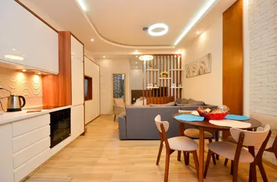 a kitchen and living room with a table and chairs at Djardin in Kotor