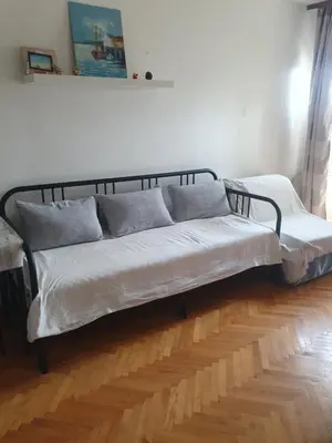a bed with two pillows on it in a room at Apartman na najboljoj lokaciji , nedaleko od plaže in Bar