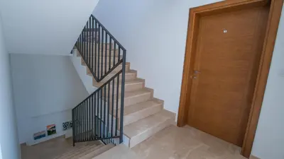 a staircase with a wooden door in a house at Zia Apartments in Bar