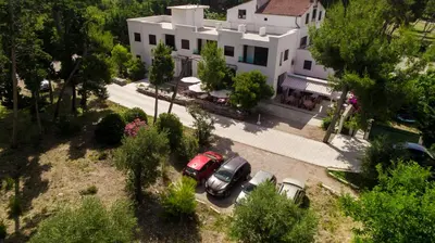 an aerial view of a house with cars parked in front at Zia Apartments in Bar