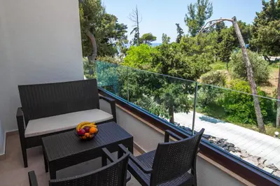 a balcony with a table and chairs and a view at Zia Apartments in Bar