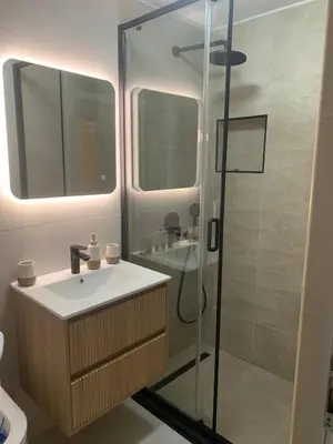 a bathroom with a sink and a glass shower at Family Seaside Holm Oak Villa with Private Rocky Beach in Bar