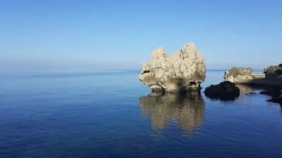 a large rock in the middle of the water at Family Seaside Holm Oak Villa with Private Rocky Beach in Bar