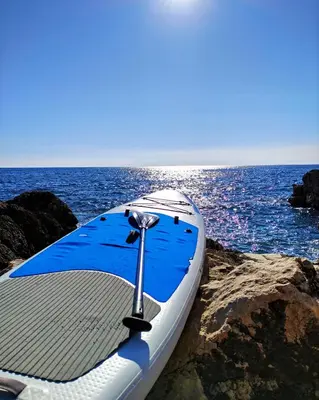 a boat sitting on the rocks near the ocean at Family Seaside Holm Oak Villa with Private Rocky Beach in Bar