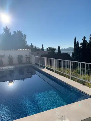 a swimming pool with a white fence at Apartman Ana Zeleni pojas in Bar