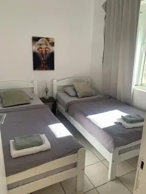 a bedroom with two beds and a window at Apartman Ana Zeleni pojas in Bar