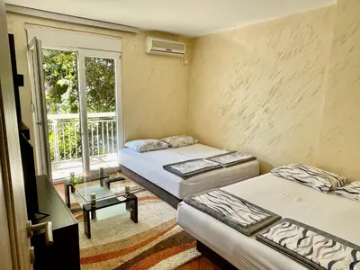 a room with two beds and a window at Apartman Sofija Budva in Budva