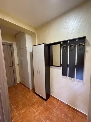 a room with a bathroom with hangers on the wall at Apartman Sofija Budva in Budva