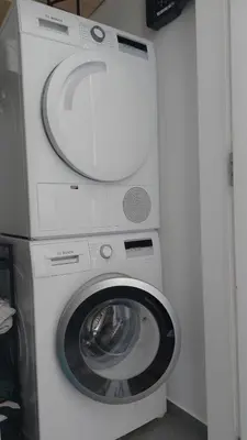 a white washer and dryer in a room at Modern Top Floor Sea View 3BR with Pools, Spa & Fitness in Becici