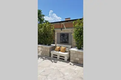 a fireplace in a garden with two pillows at Modern Top Floor Sea View 3BR with Pools, Spa & Fitness in Becici