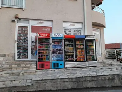 a store window with a bunch of drinks in it at Modern Top Floor Sea View 3BR with Pools, Spa & Fitness in Becici