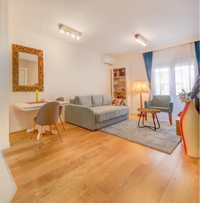 a living room with a couch and a table at Consulate in Podgorica