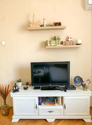 a flat screen tv on a white entertainment center at Cute, spacious apt in the heart of the old town in Podgorica