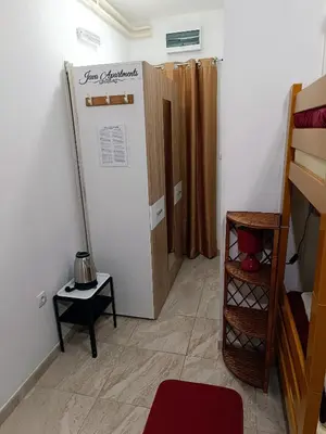 a small room with a bunk bed and a closet at Java apartments - S & J in Dobrota