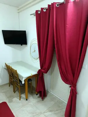 a room with a table and a red curtain at Java apartments - S & J in Dobrota