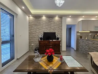 a living room with a table with flowers on it at Apartment Angel in Kotor