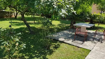 a table and chairs sitting in a garden at Apartment Angel in Kotor