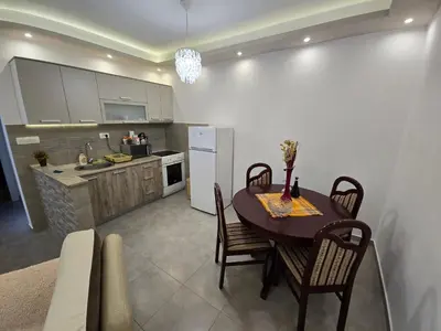 a kitchen and dining room with a table and a refrigerator at Apartment Angel in Kotor