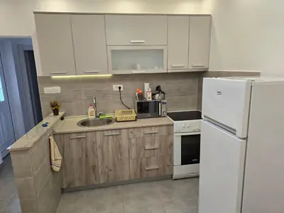 a kitchen with white appliances and a white refrigerator at Apartment Angel in Kotor