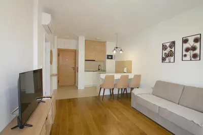 a living room with a couch and a kitchen at Apartments LORA Zmajeva, 7 in Budva