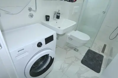 a bathroom with a washing machine and a sink at Apartments LORA Zmajeva, 7 in Budva
