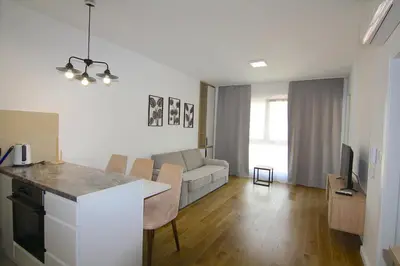 a kitchen and living room with a couch and a table at Apartments LORA Zmajeva, 7 in Budva