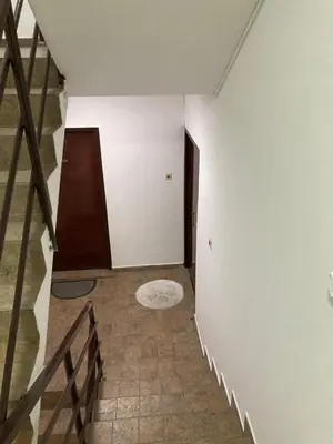 an empty room with a staircase and a stair case at Stan na dan Bogdan in Podgorica
