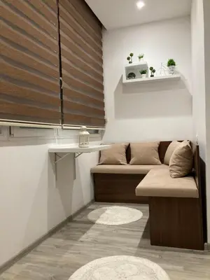 a living room with two beds and a table at Stan na dan Bogdan in Podgorica