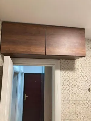 a wooden cabinet above a door in a room at Stan na dan Bogdan in Podgorica