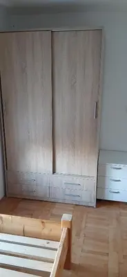 a room with two wooden cabinets and a wooden bench at SKADAr LAKE SARA 3 DM in Cetinje
