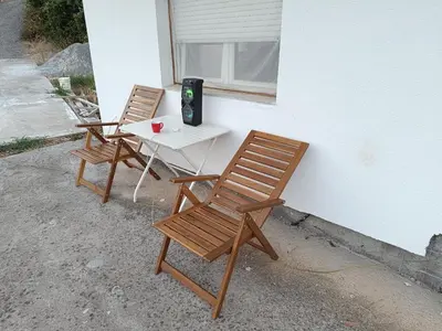 two chairs sitting next to a table with a laptop at SKADAr LAKE SARA 3 DM in Cetinje