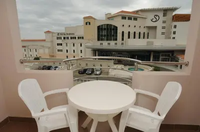 a white table and chairs on a balcony at Hotel Anita in Budva