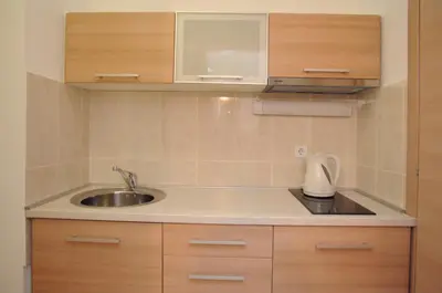 a kitchen with a sink and a counter top at Hotel Anita in Budva