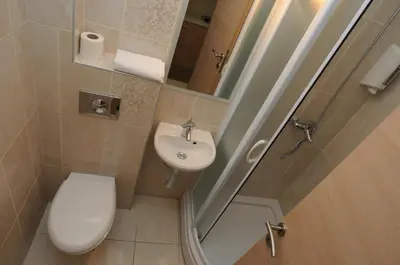 a small bathroom with a toilet and a sink at Hotel Anita in Budva