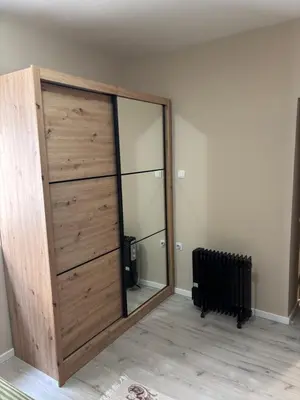a large wooden sliding door in a room at Max Apartments in Podgorica