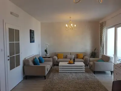 a living room with couches and a coffee table at Apartments Peđa in Sveti Stefan
