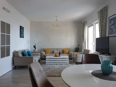 a living room with a couch and a table at Apartments Peđa in Sveti Stefan