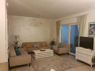 a living room with a couch and a tv at Apartments Peđa in Sveti Stefan