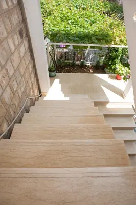 a set of stairs leading up to a house at Apartments Peđa in Sveti Stefan