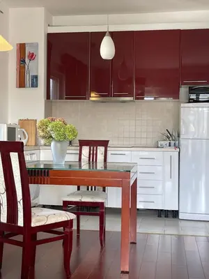 a kitchen with a table and chairs and a refrigerator at Belveder Alevtina in Rafailovici