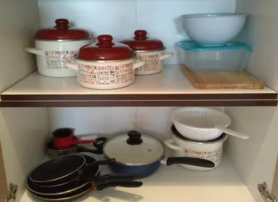 a shelf with pots and pans and other kitchen items at Belveder Alevtina in Rafailovici