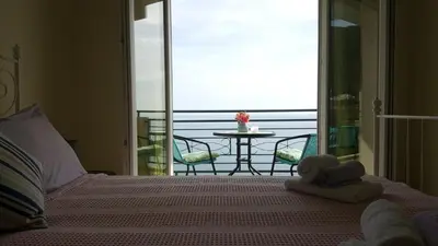 a bedroom with a bed with a view of the ocean at Lighthouse Apartments in Budva