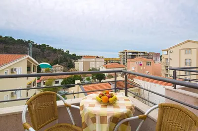 a bowl of fruit on a table on a balcony at Petrovac Holiday Apartments in Petrovac na Moru
