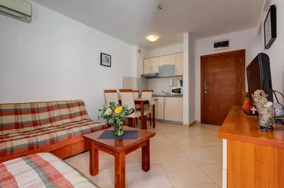 a living room with a couch and a table at Petrovac Holiday Apartments in Petrovac na Moru