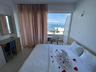 a bedroom with a bed with a view of the ocean at Rosa Negra in Ulcinj