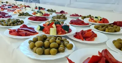 a table with plates of different types of food at Rosa Negra in Ulcinj