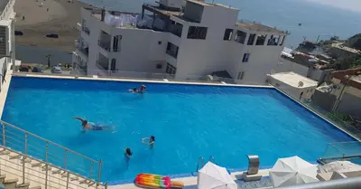 a group of people swimming in a large swimming pool at Rosa Negra in Ulcinj
