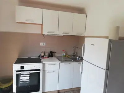 a kitchen with white appliances and a white refrigerator at Apartmani EMMA in Kotor
